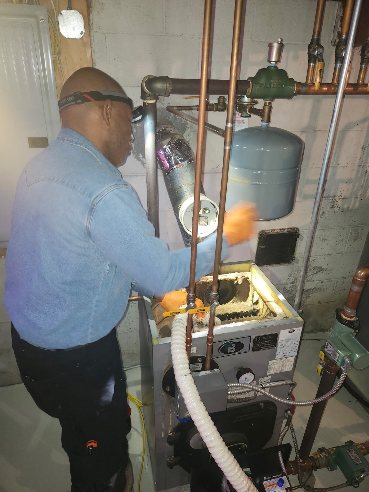 Broth Condition Air owner servicing a residential boiler